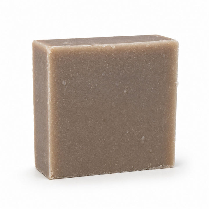 Dirty Bee Choco Choco Milk Soap Bar, a square matte taupe-brown textured soap bar, on a white background.
