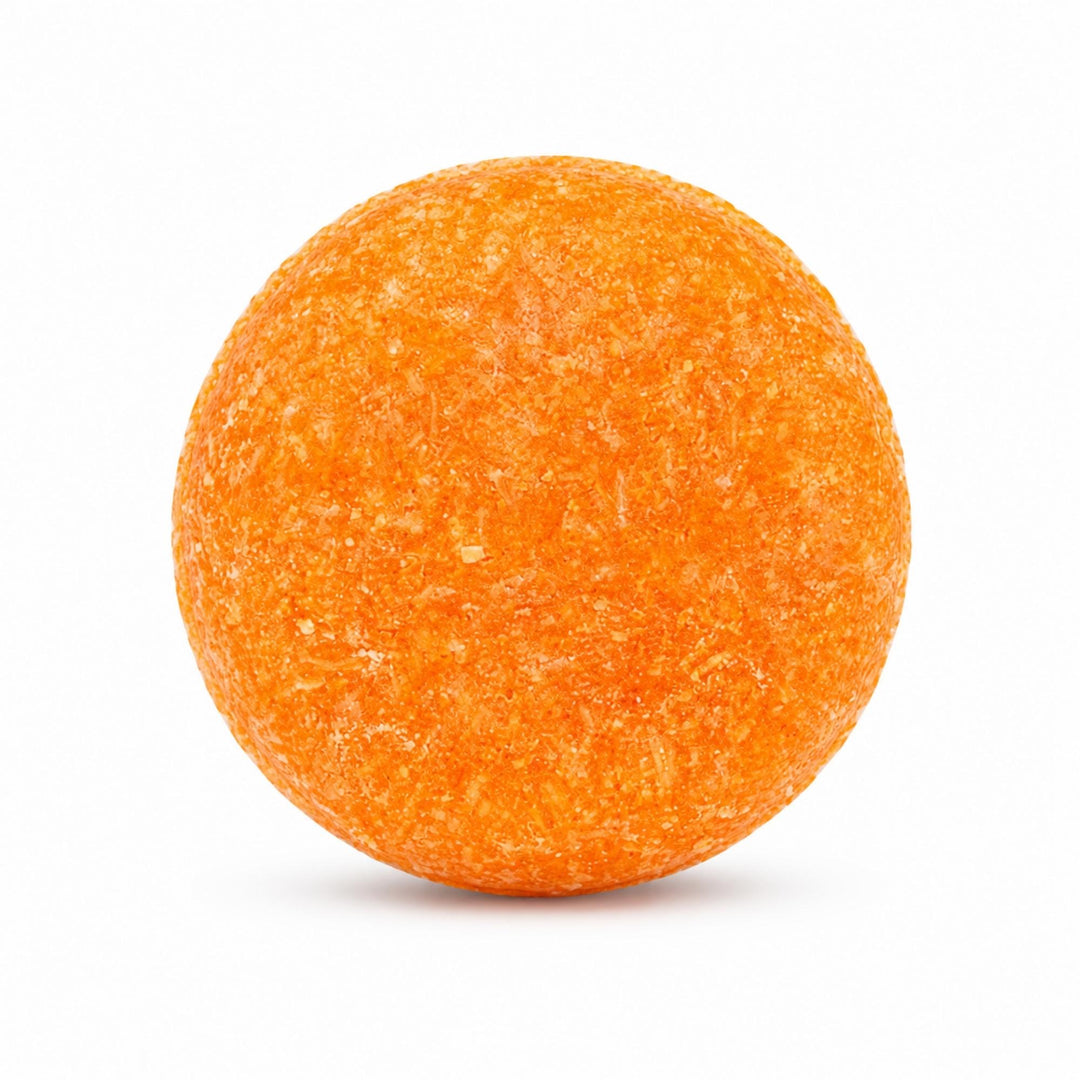 Dirty Bee Florida Fresh Shampoo Bar, a round textured orange shampoo bar, on a white background.