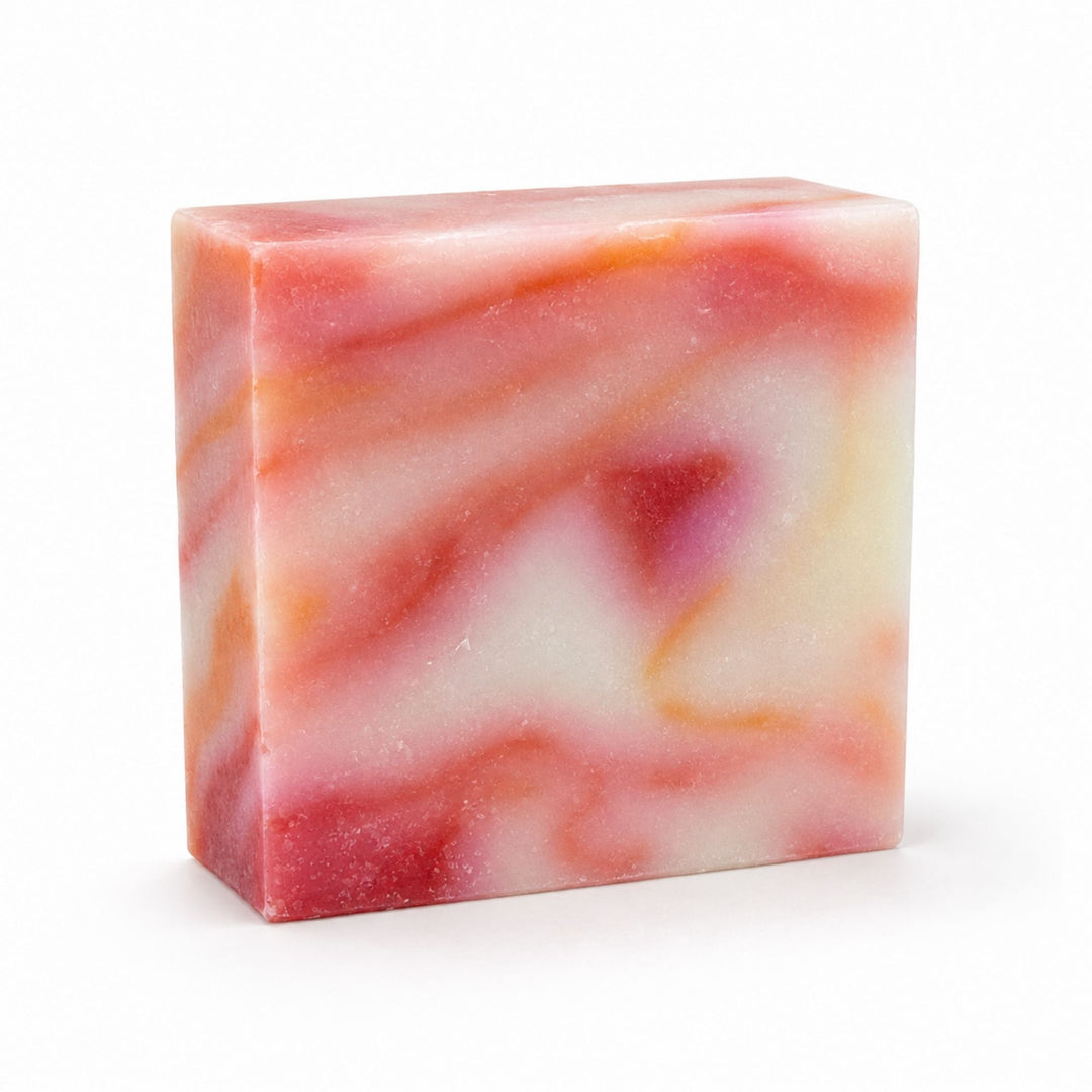 Dirty Bee Jamaica Me Crazy Soap Bar, a square bar with a marbled swirl of pink, red, orange, and white, on a white background.
