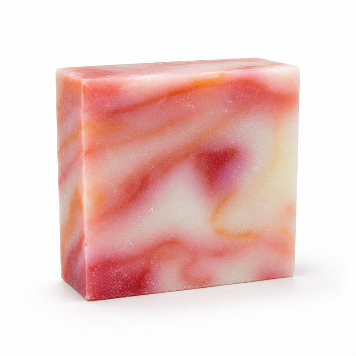 Dirty Bee Jamaica Me Crazy Soap Bar, a square bar with a marbled swirl of pink, red, orange, and white, on a white background.