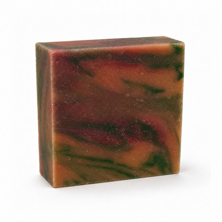 Dirty Bee Mango Tango Soap Bar, a square bar with a marbled pattern of orange, brown, and dark green, on a white background.