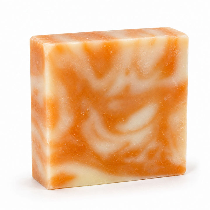 Dirty Bee Orange Dreamsicle Soap Bar, a square bar with a marbled orange and cream swirl, on a white background.