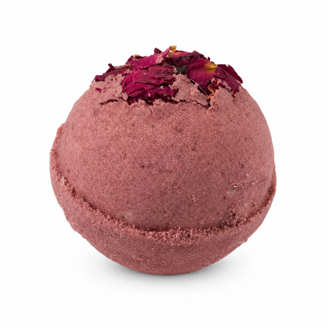 Dirty Bee Rose Garden Bath Bomb, a round dusty-rose bath bomb topped with dried rose petals, on a white background.