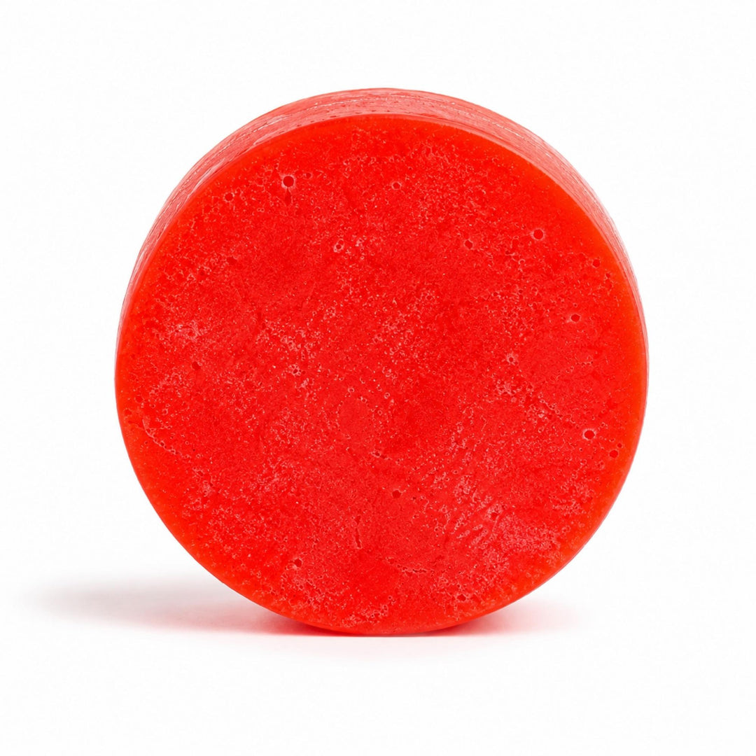 Dirty Bee Volcano Conditioner Bar, a round bright red textured bar on a clean white background.