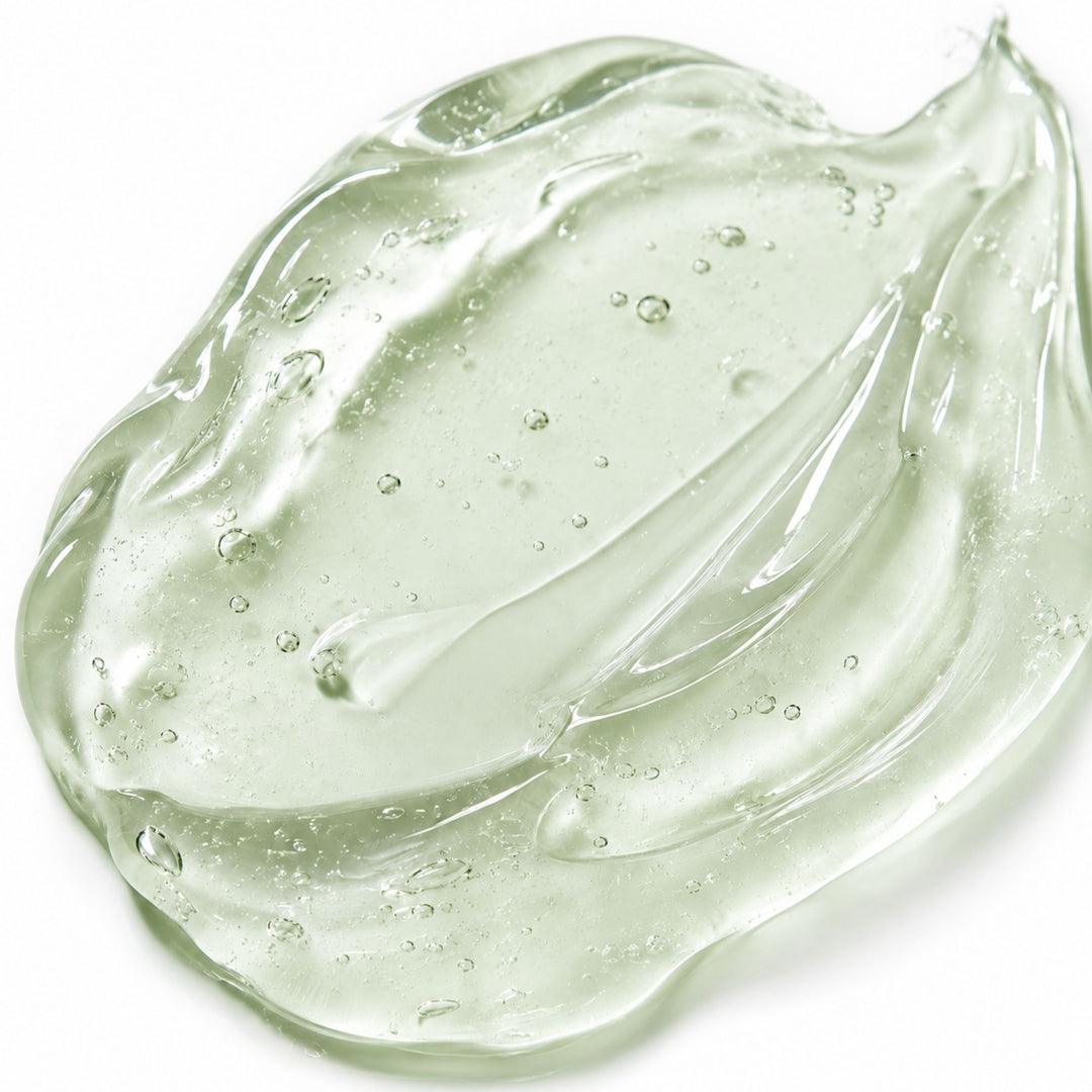 Close-up of translucent aloe gel on a white background