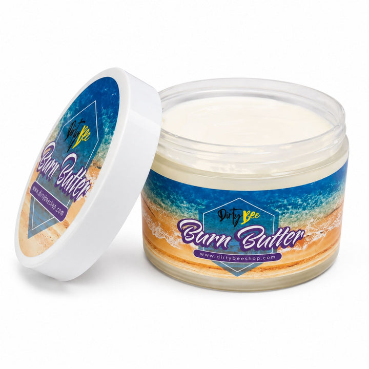 Dirty Bee Burn Butter in an open clear jar with white lid, showing the creamy body butter texture on a clean white background.