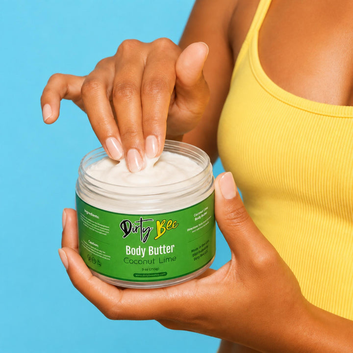 Tan woman in a yellow top holding open Dirty Bee Coconut Lime Body Butter against a bright blue background.